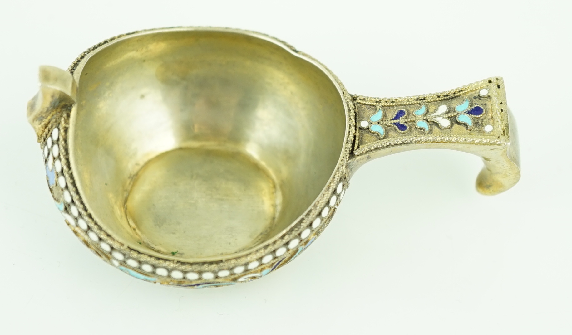 A late 19th/early 20th century Russian 84 zolotnik silver gilt and polychrome enamelled kovsh